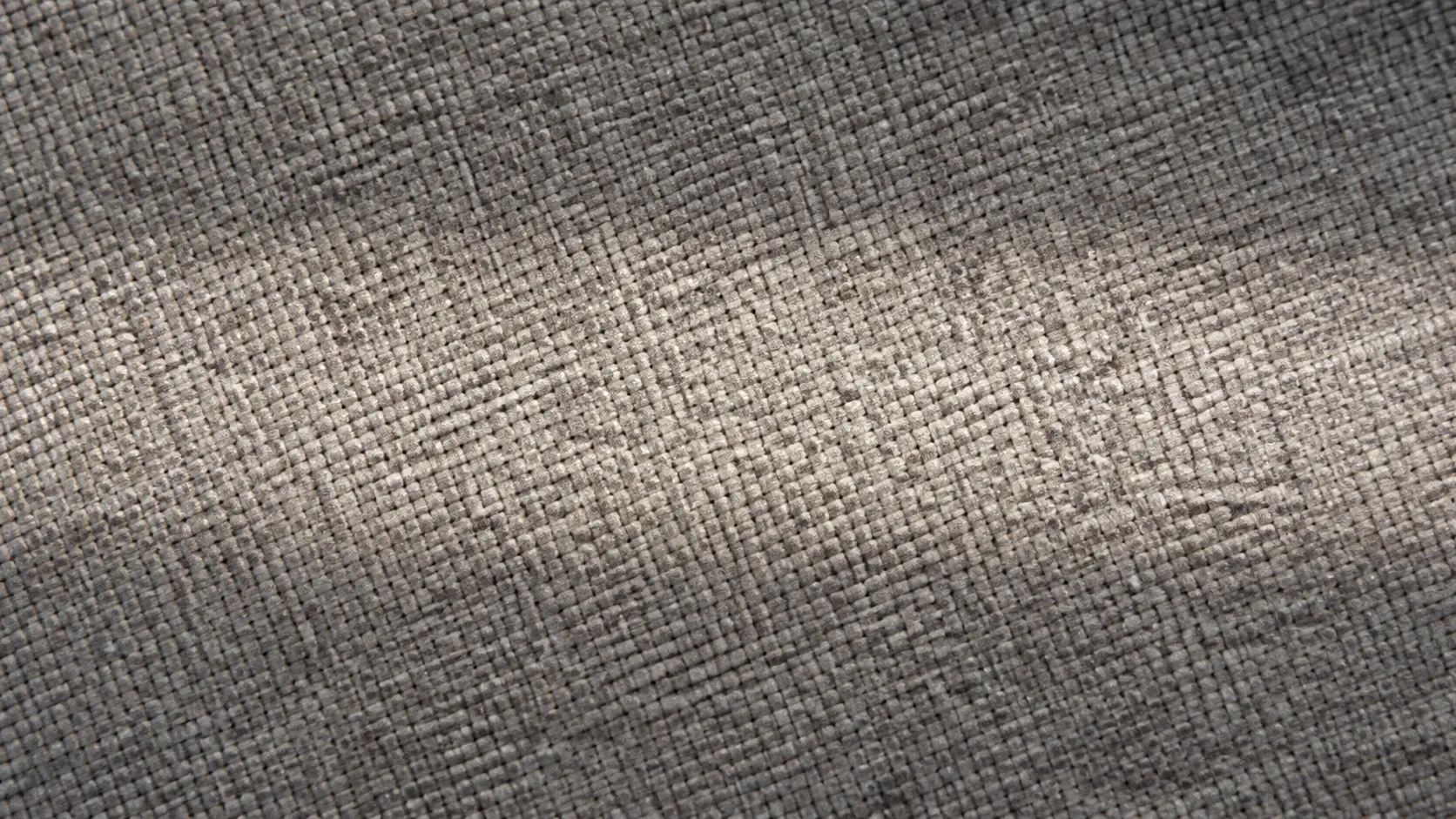 Close-up of grey woven sofa fabric with a brighter, freshly cleaned band running through the middle of the pile